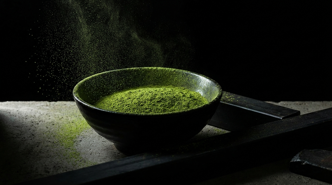 Bowl of vivid green Uji matcha powder on a dark industrial surface